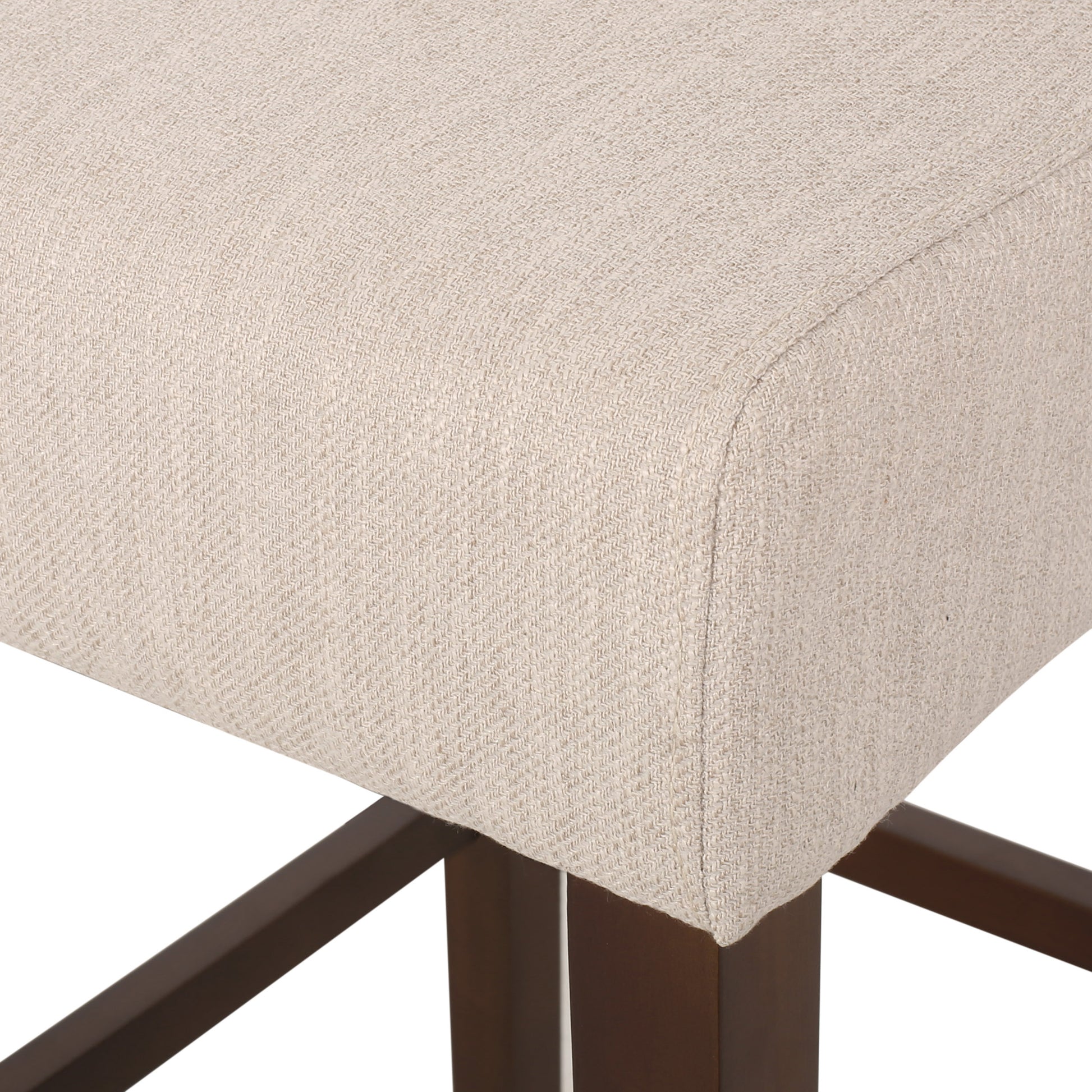 Closeup of natural linen fabric seat cushion with dark wood legs