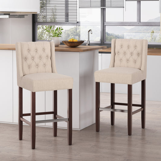 Two beige tufted bar stools with dark wood legs