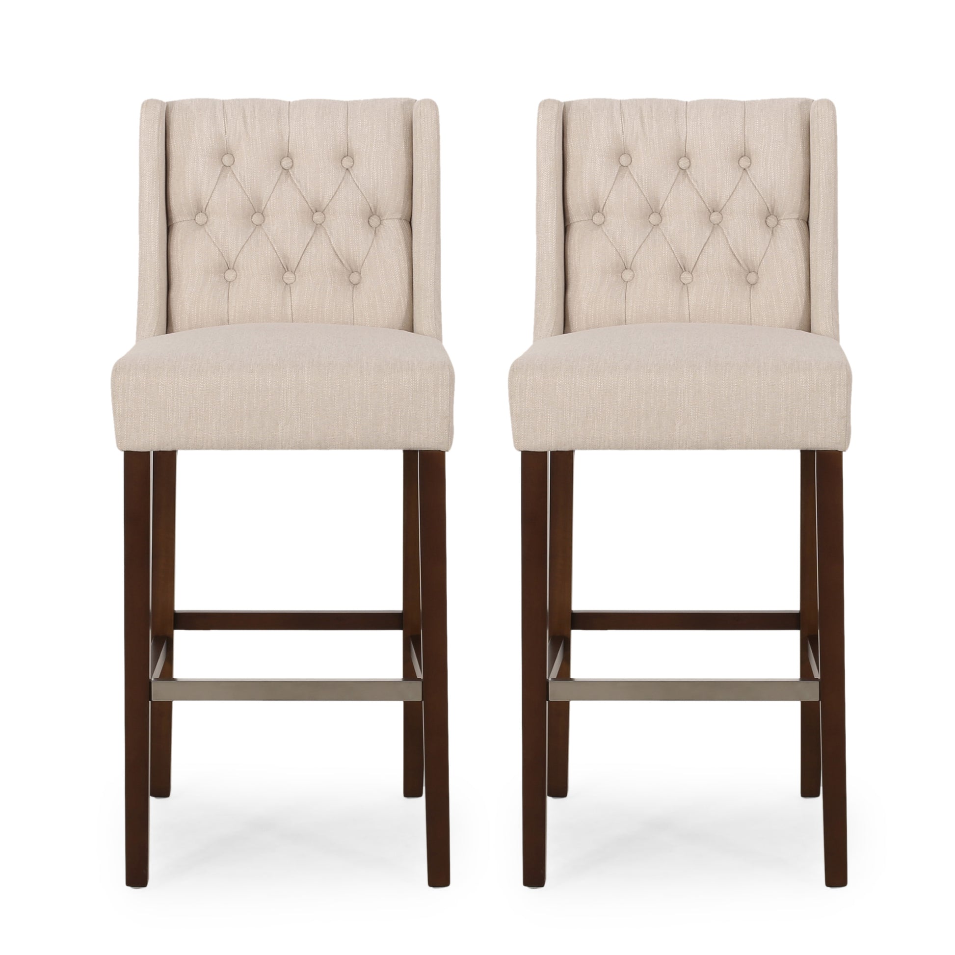 Two tufted beige fabric bar stools with dark wood legs and metal footrests