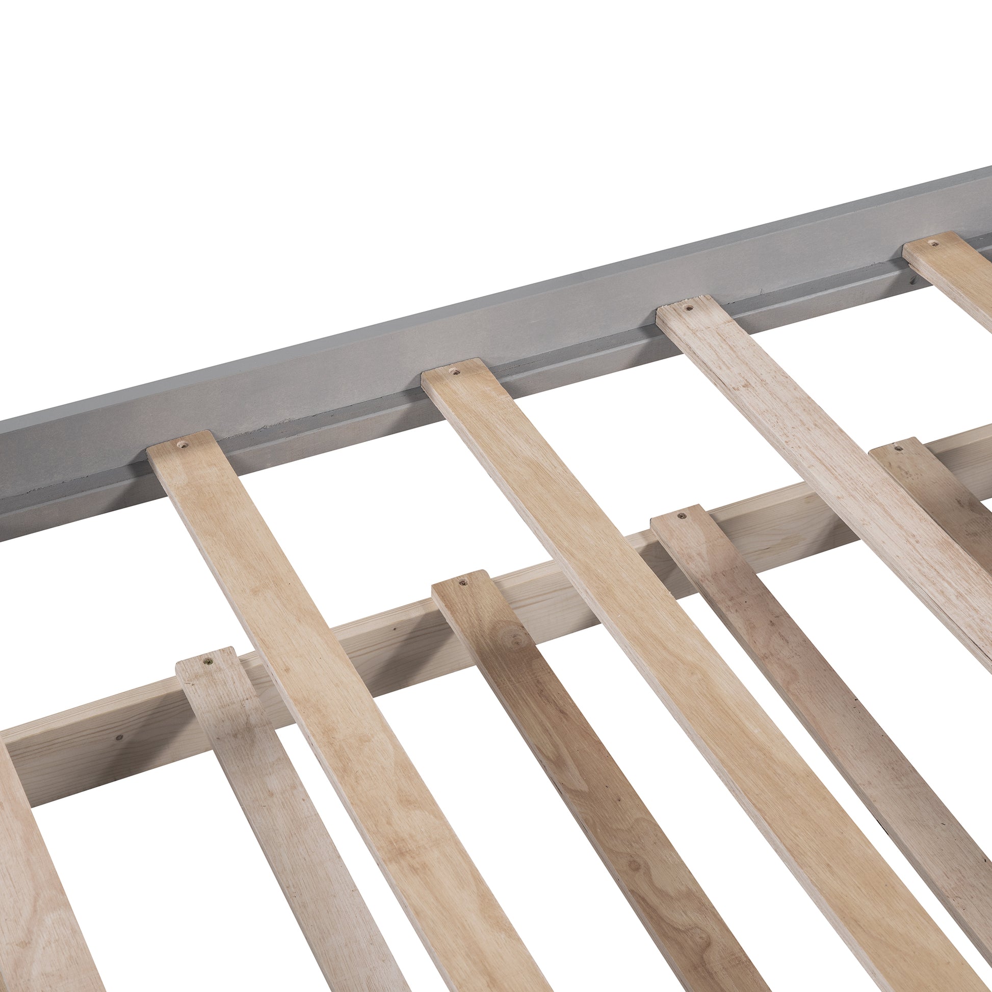 Closeup of sturdy wooden slats on a grey bed frame base
