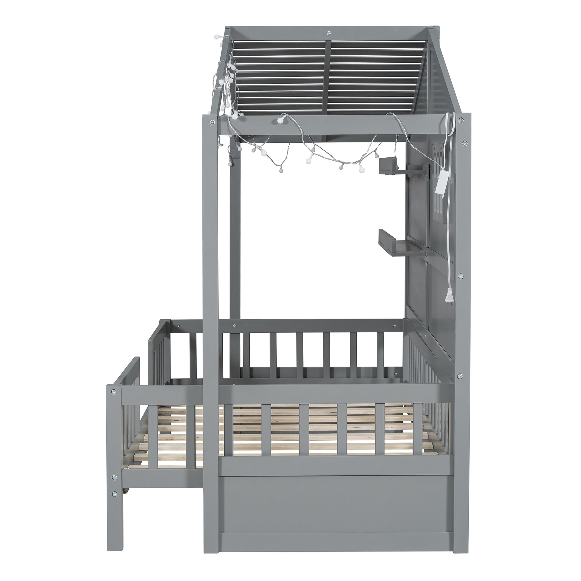 Gray wooden toddler bed with builtin railing and string lights