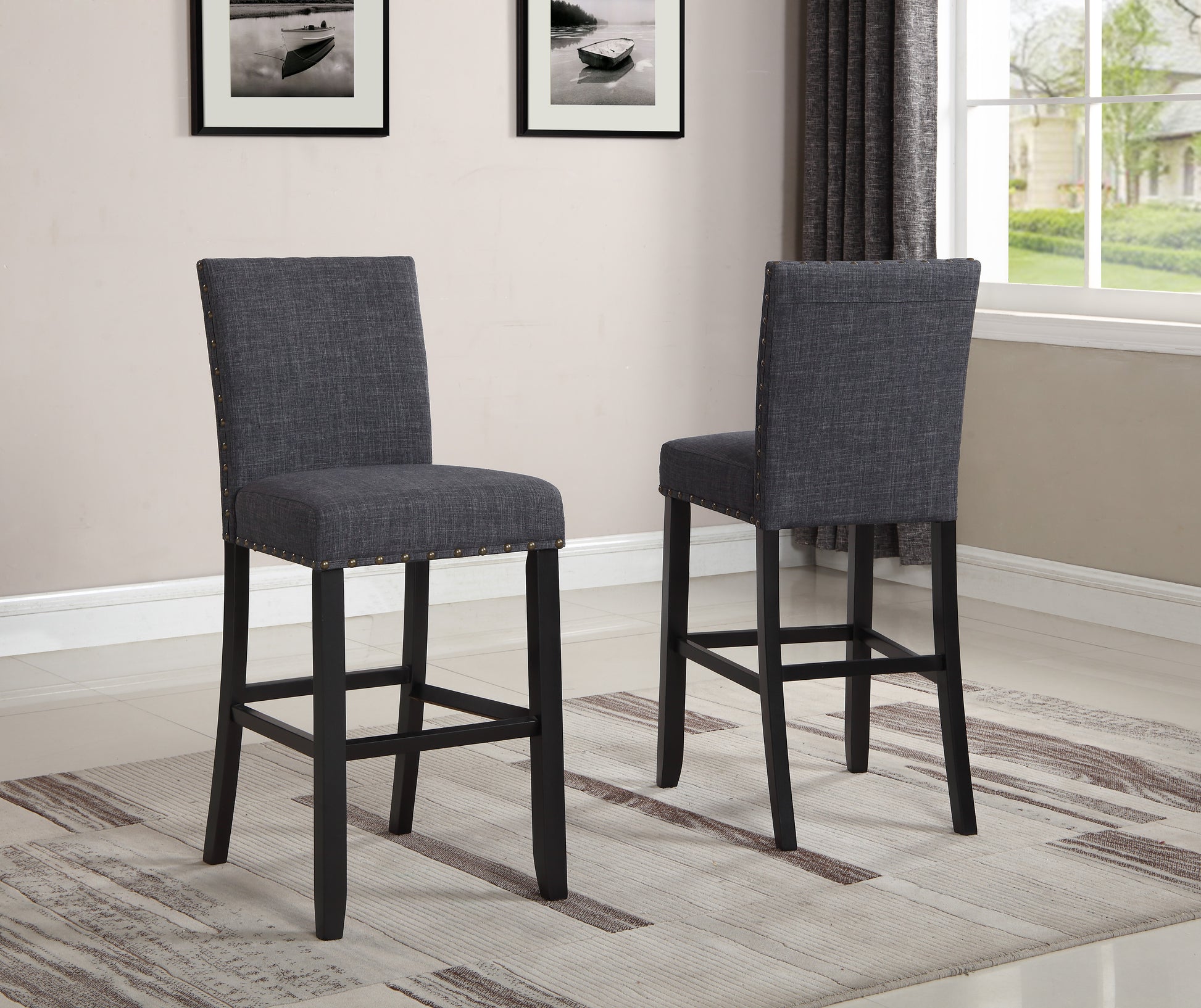 Dark grey upholstered bar stool with nailhead trim and dark wood legs