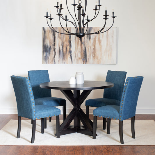 Round dark wood dining table with upholstered blue chairs