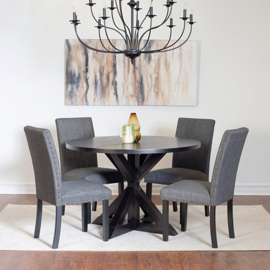 Dark wood round dining table with four upholstered gray chairs