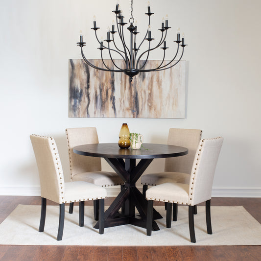 Dark wood round dining table with riveted beige upholstered chairs