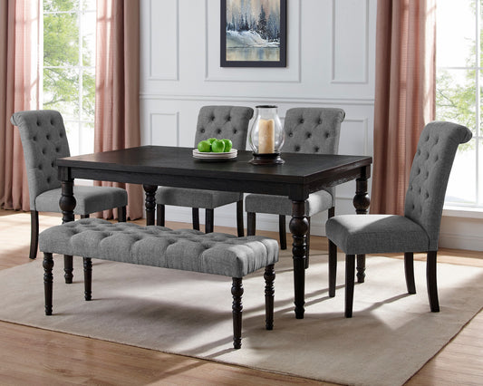 Dark wood dining table with tufted gray upholstered chairs and bench