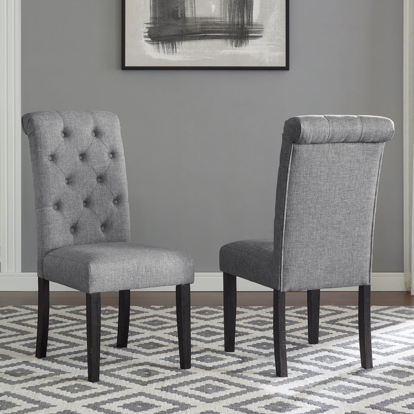Tufted grey fabric dining chair with dark wooden legs