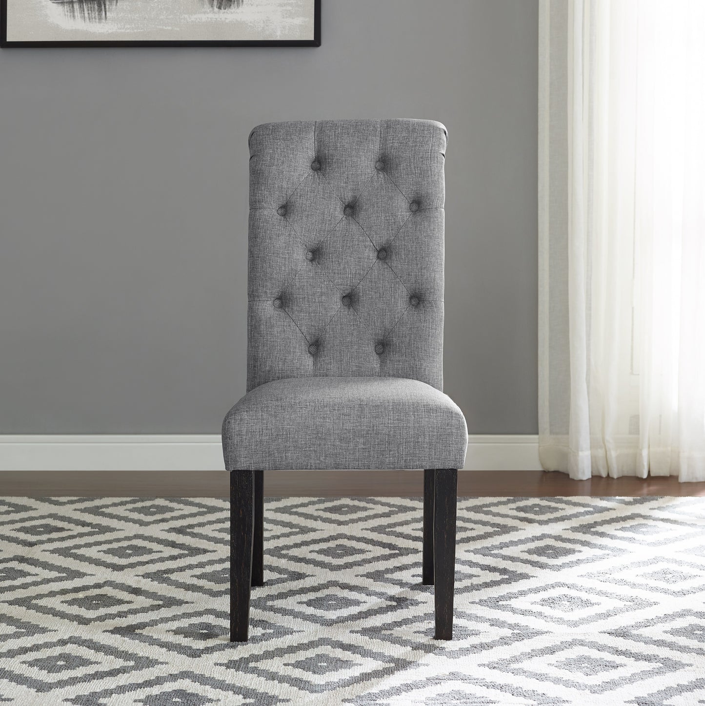 Grey upholstered dining chair with tufted back