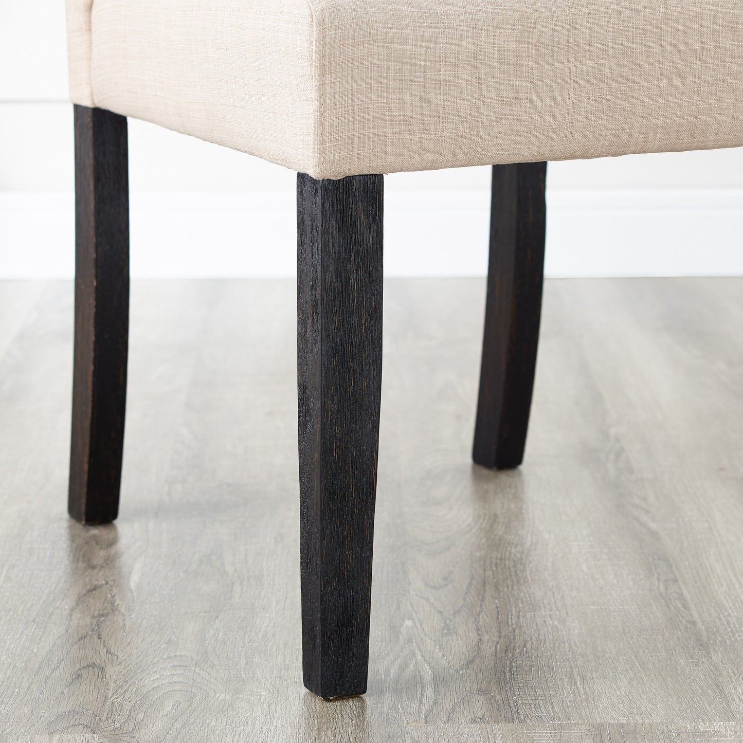 Beige linen upholstered accent chair with dark wood legs