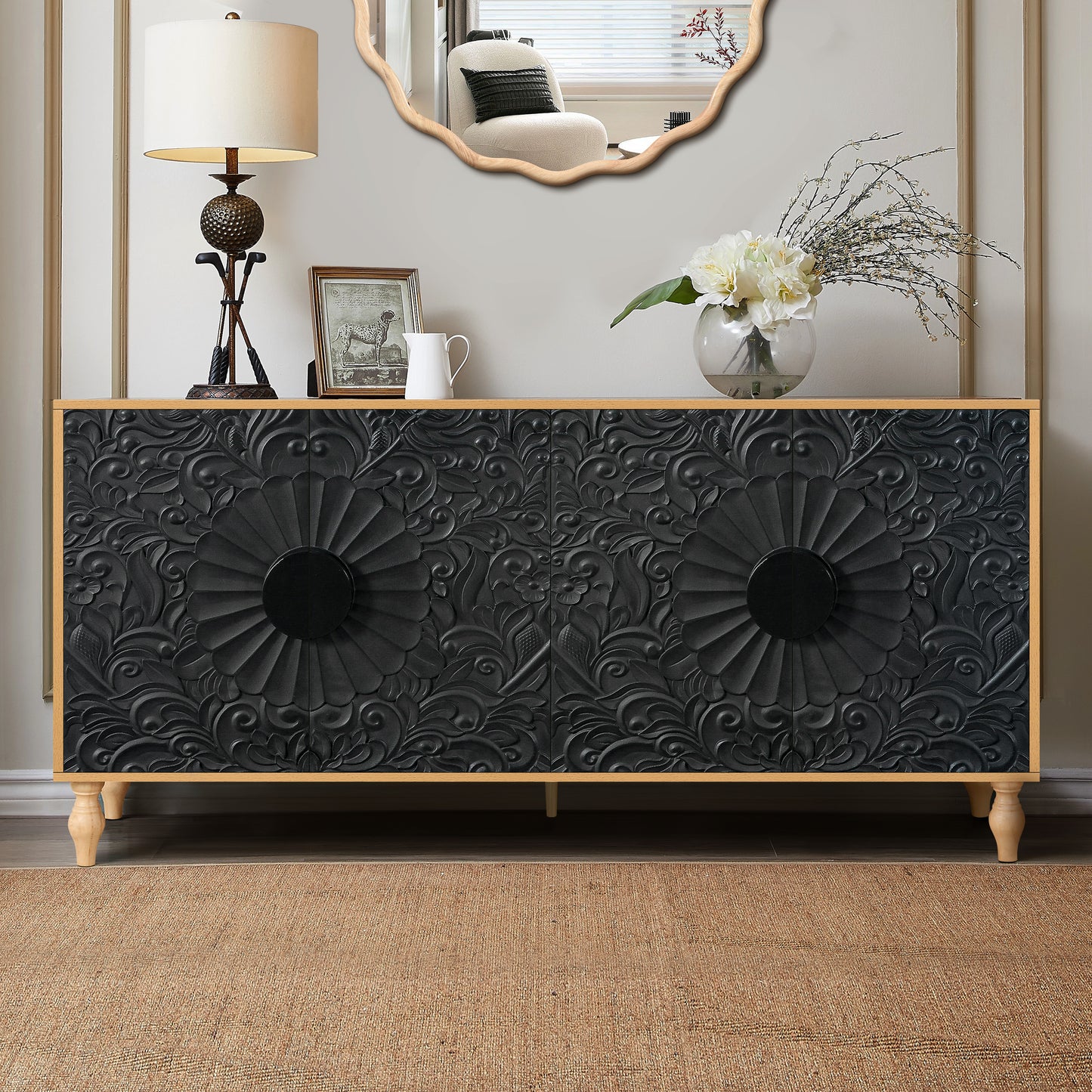 Black carved sideboard with ornate floral relief and round black knobs