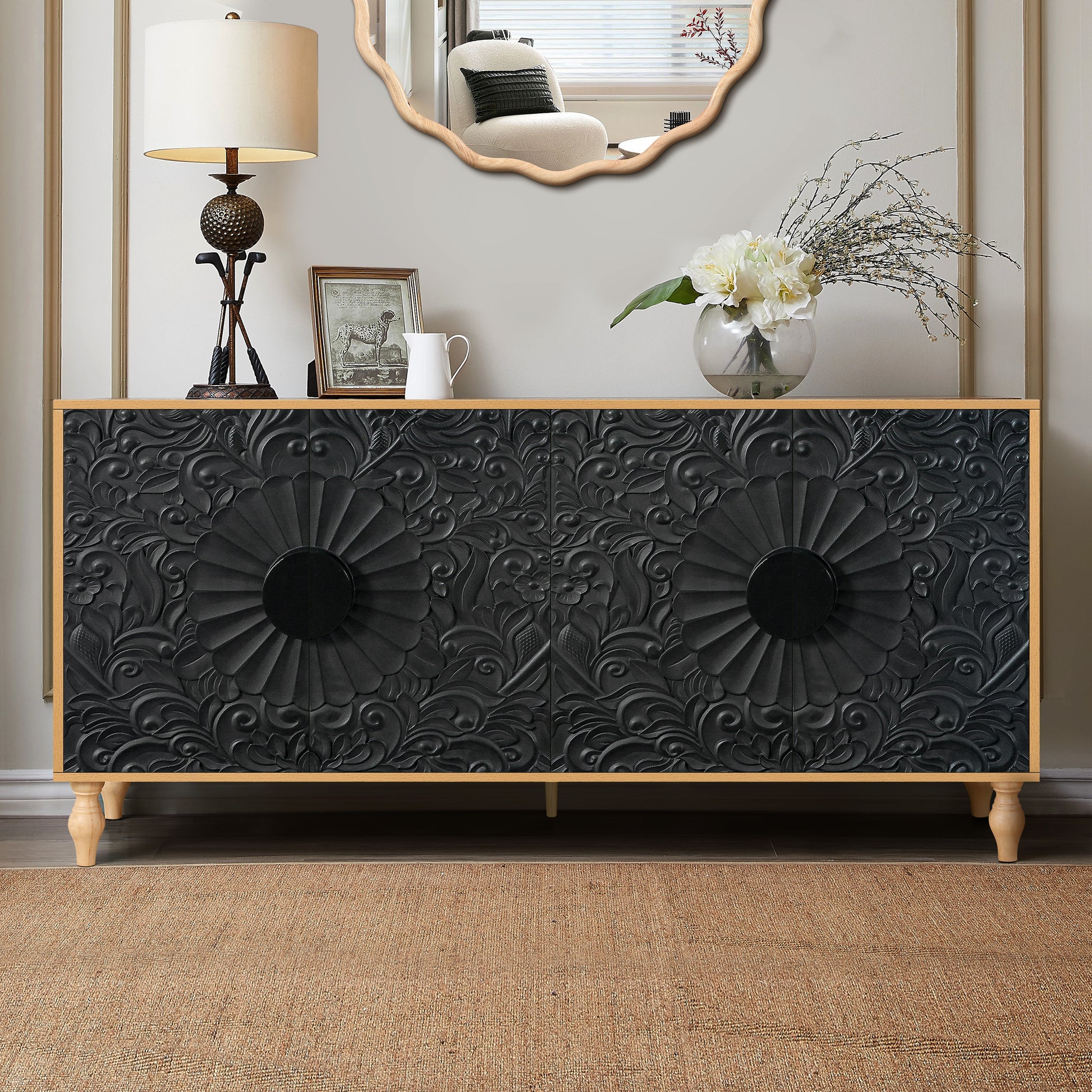 Black carved sideboard with ornate floral relief and round black knobs