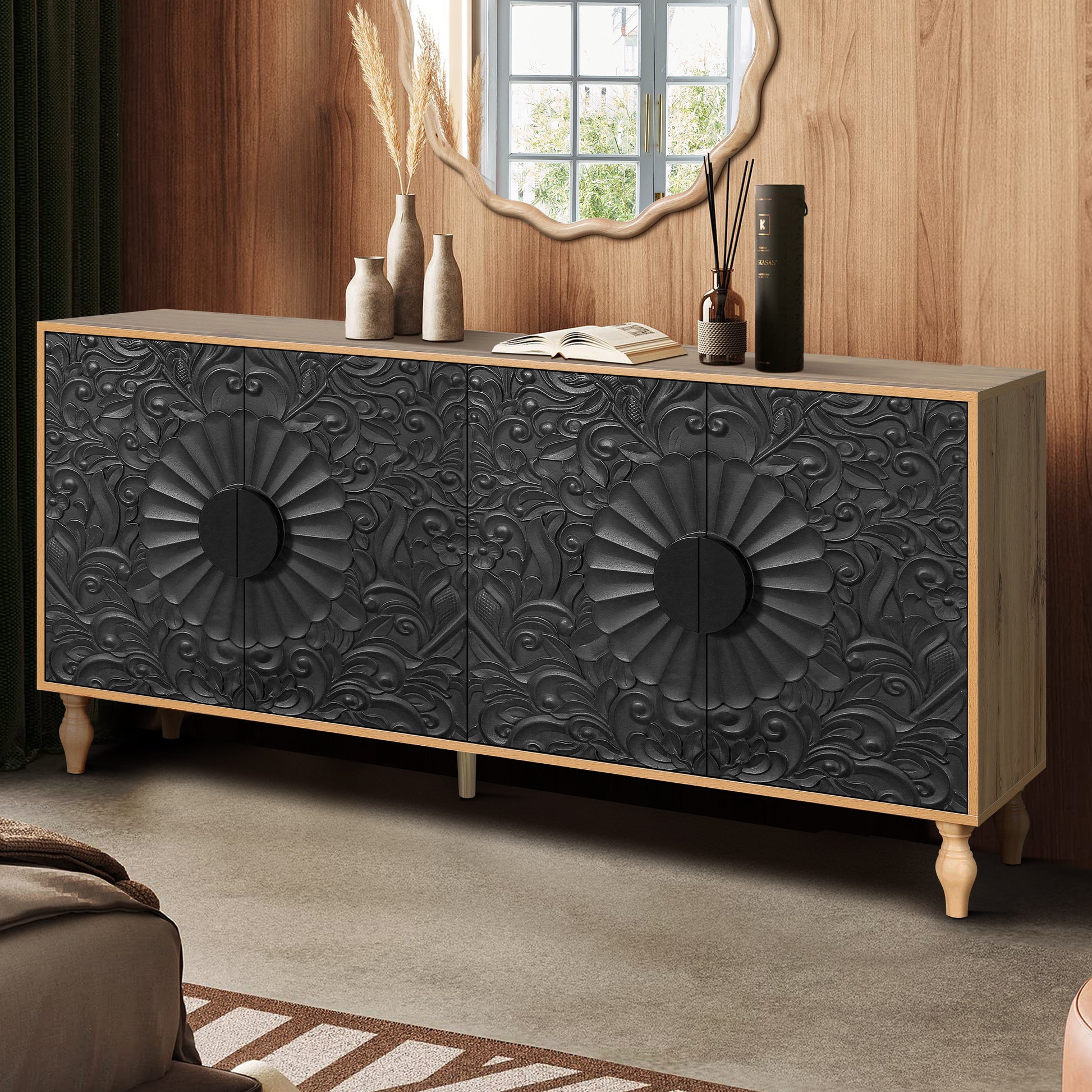 Black carved sideboard with floral motifs and brass handles