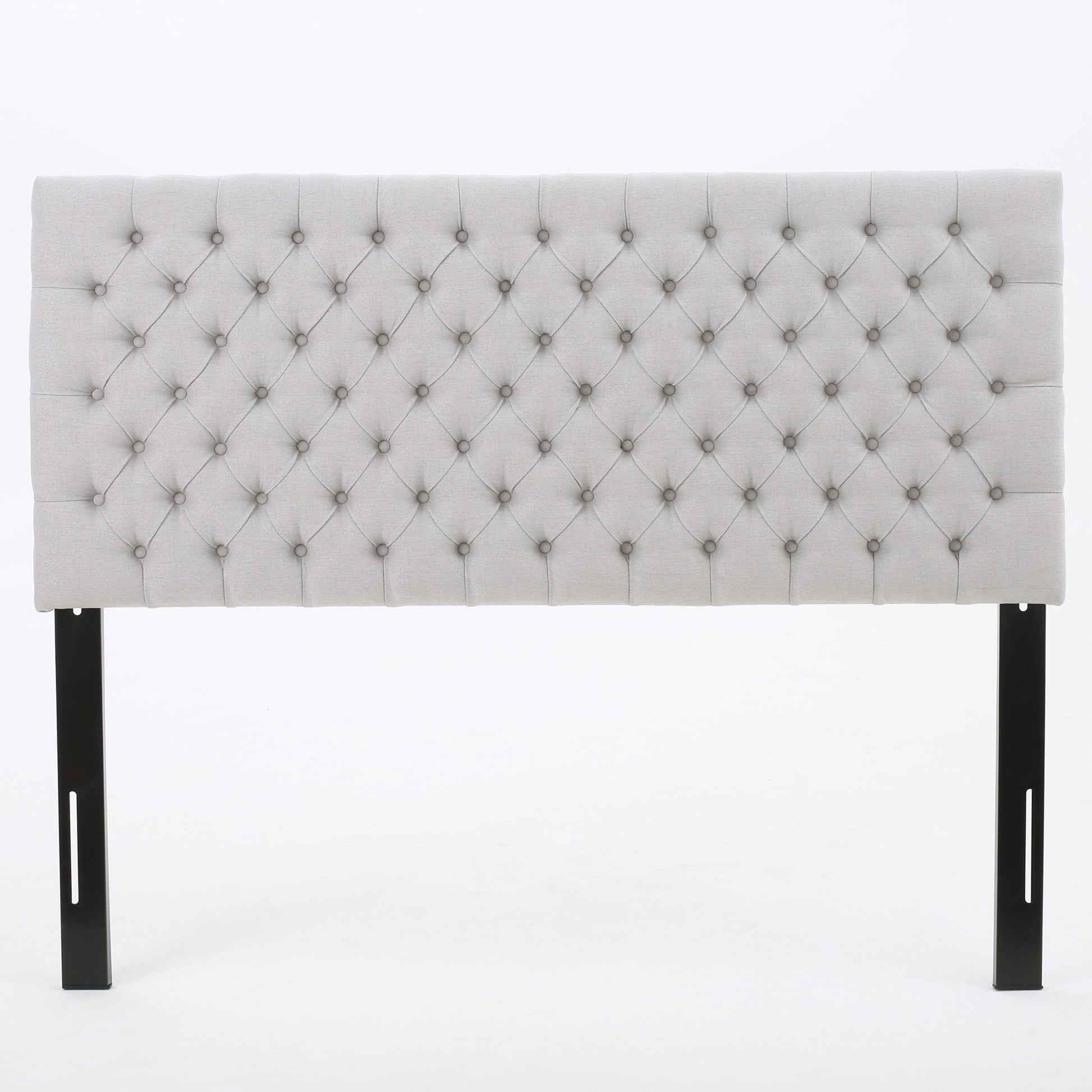 Light gray fabric upholstered tufted headboard with black metal legs