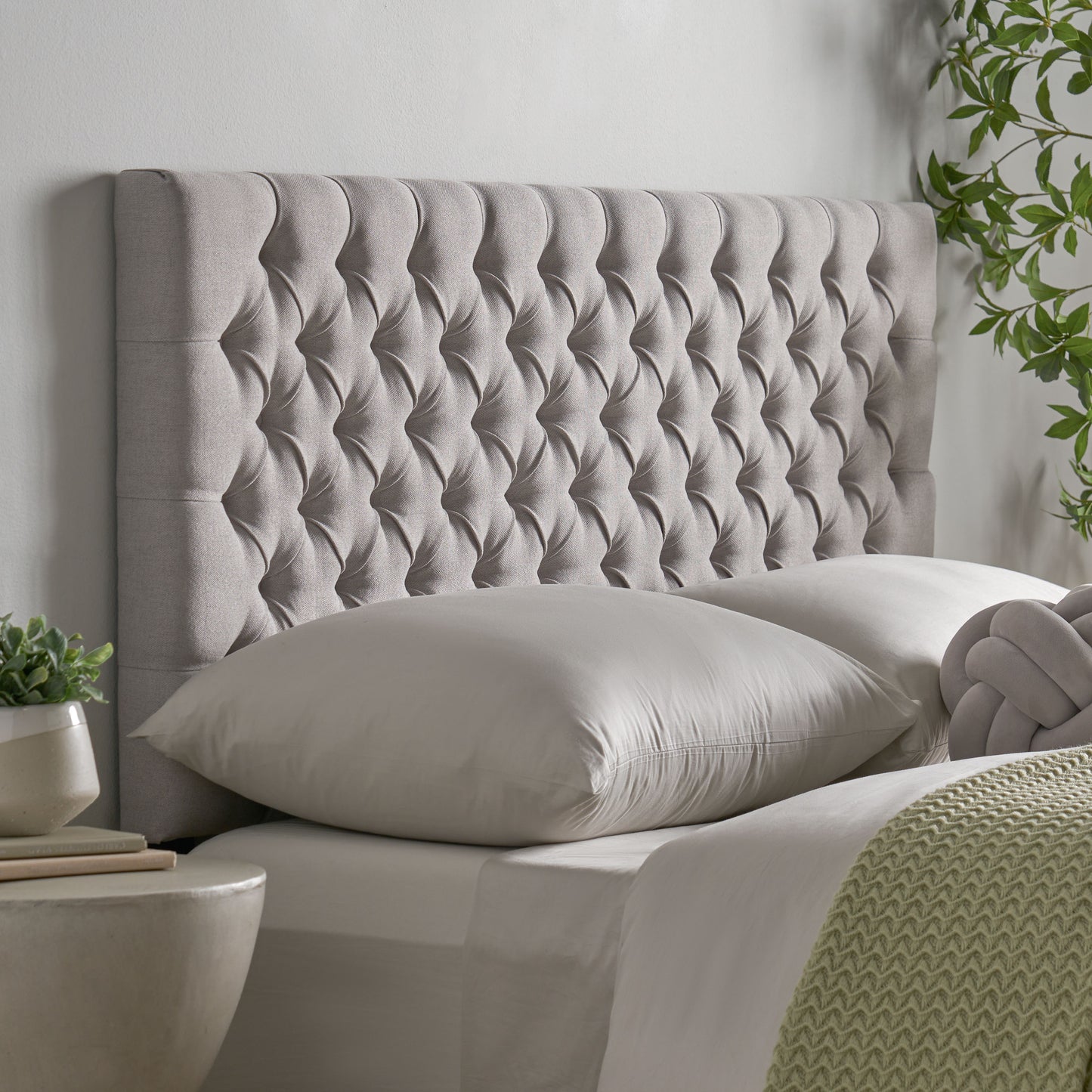 Tufted grey fabric headboard with diamond pattern