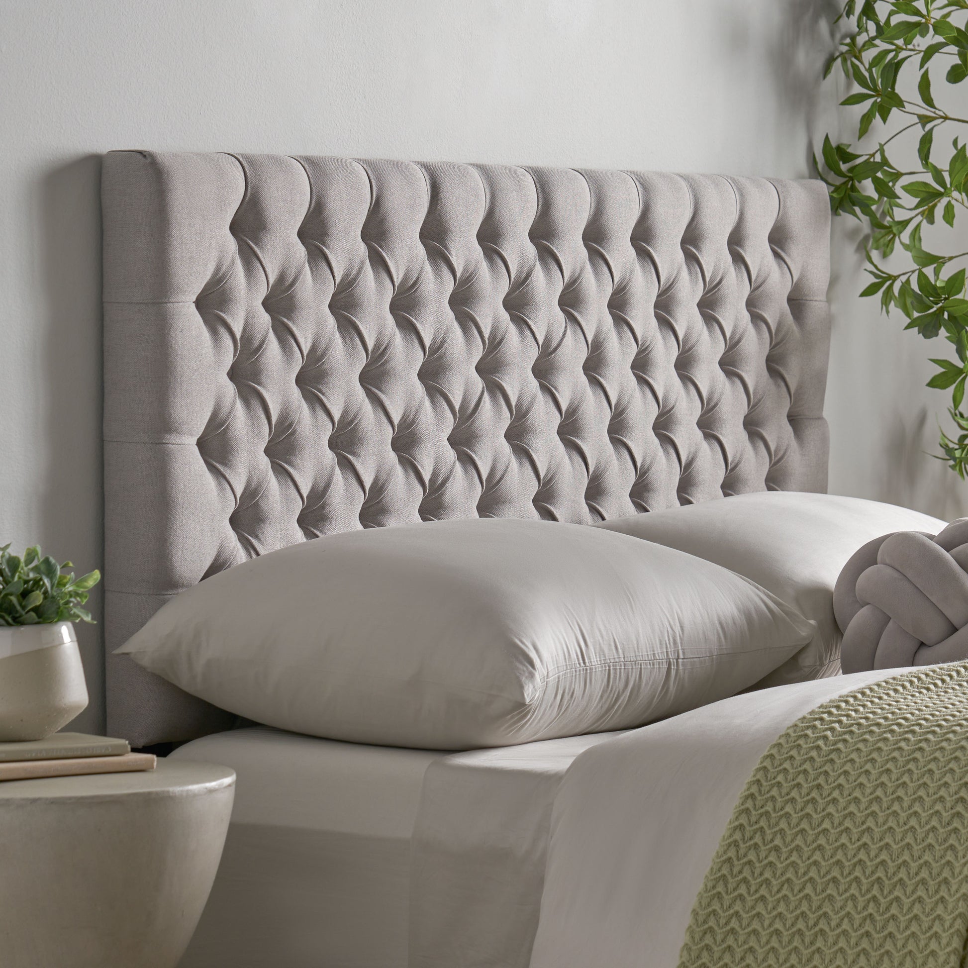 Tufted grey fabric headboard with diamond pattern