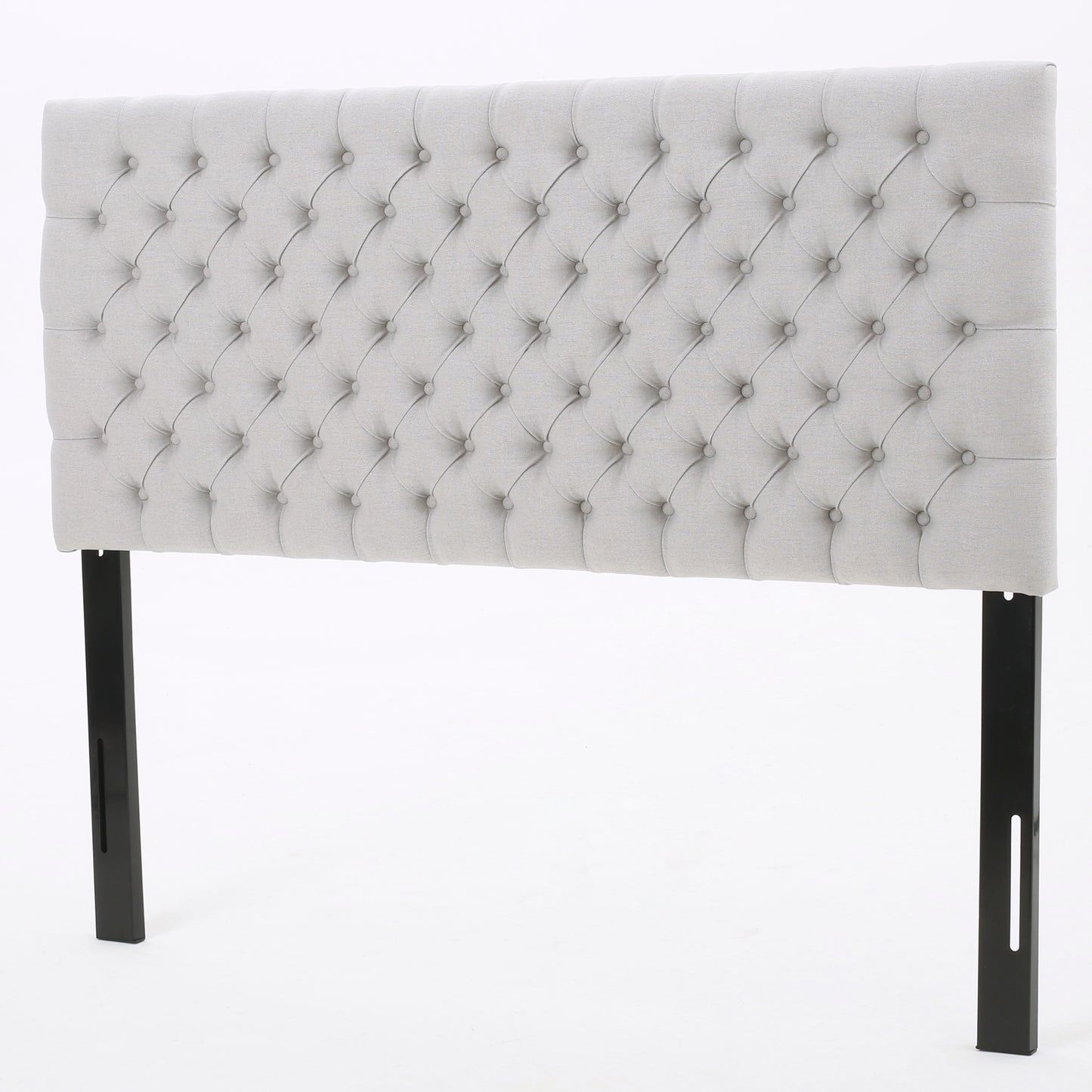 Light grey tufted fabric headboard with diamond stitching and black metal legs