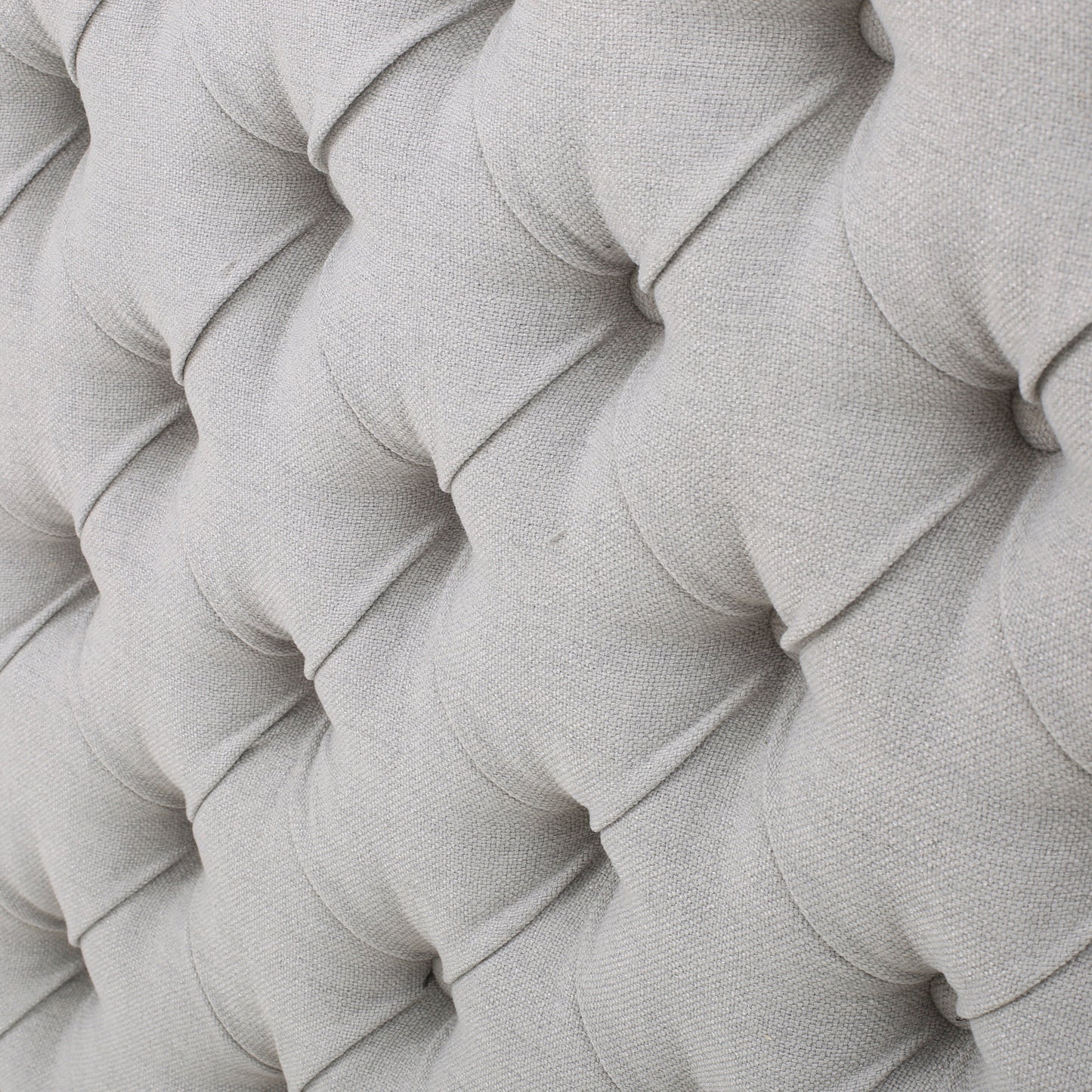 Closeup of light grey linen tufted upholstery texture