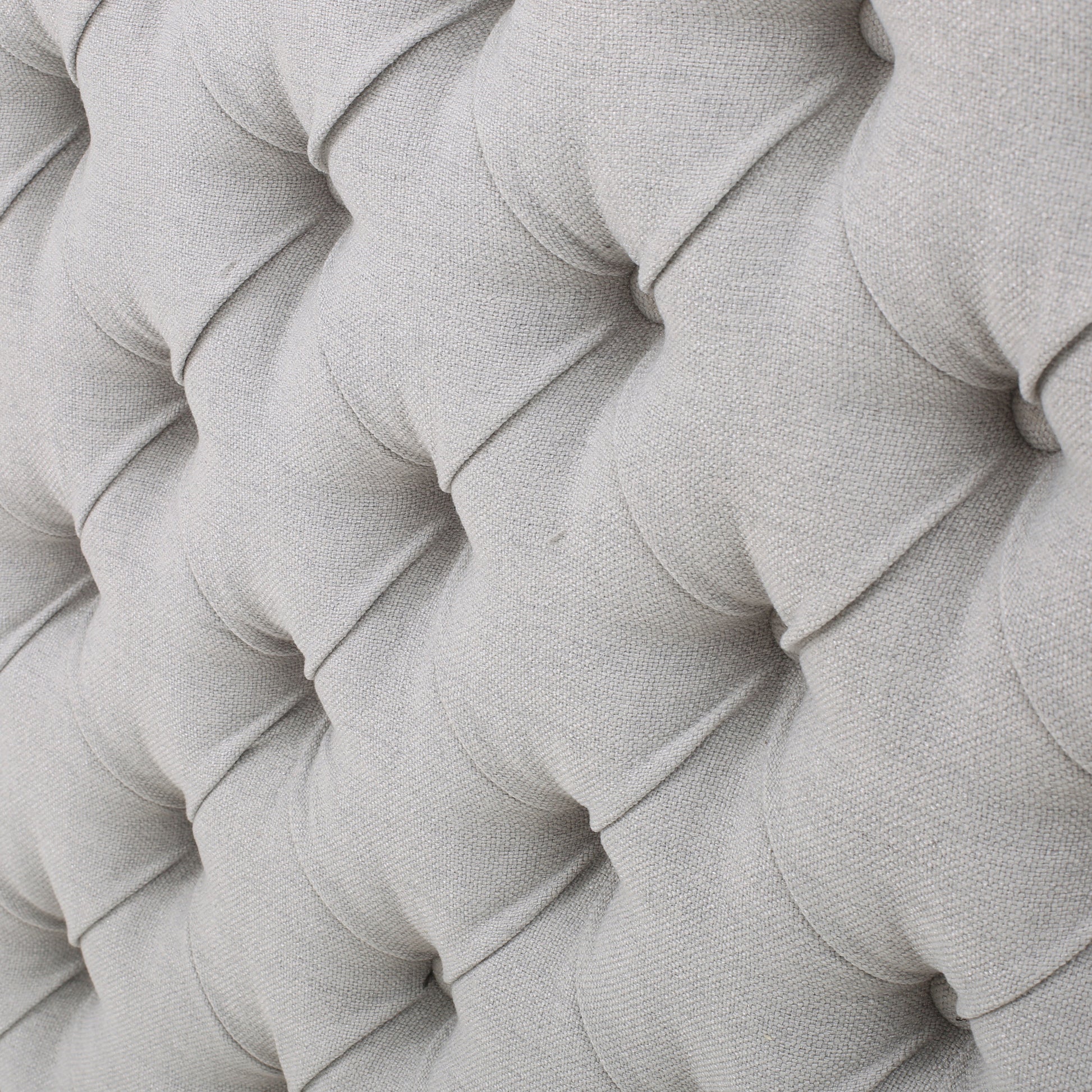 Closeup of light grey linen tufted upholstery texture