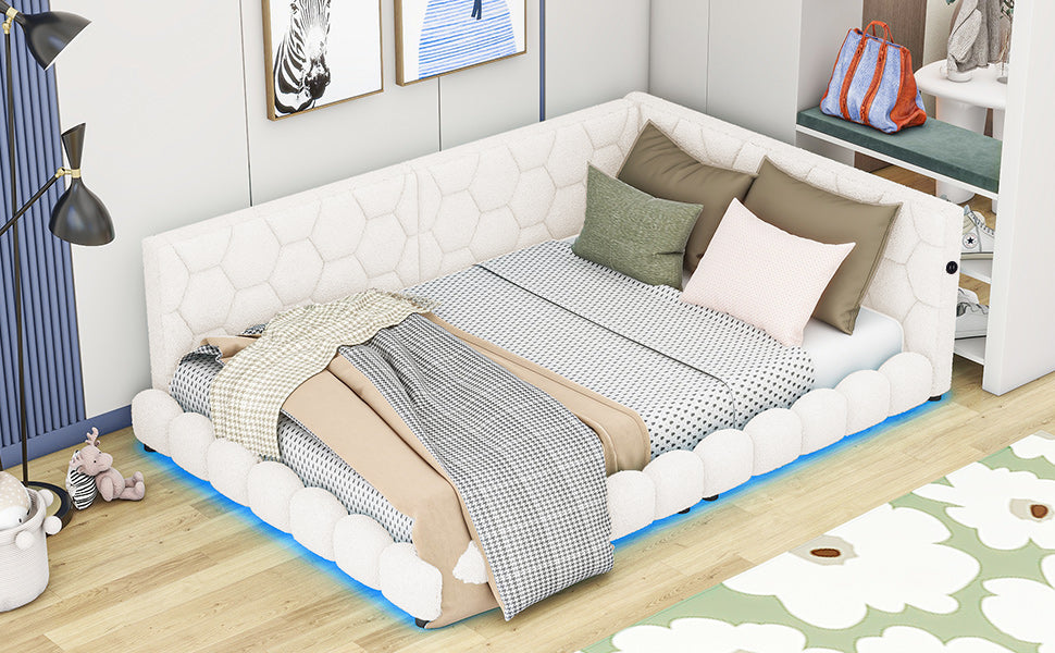 White tufted sectional daybed with plush bedding and decorative pillows