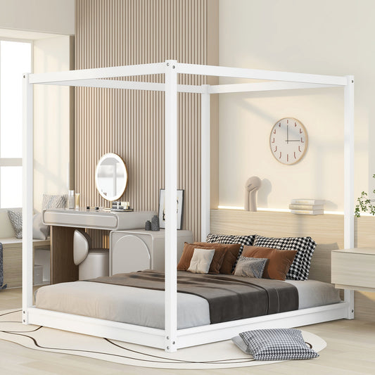 White metal canopy bed with layered bedding and decorative pillows