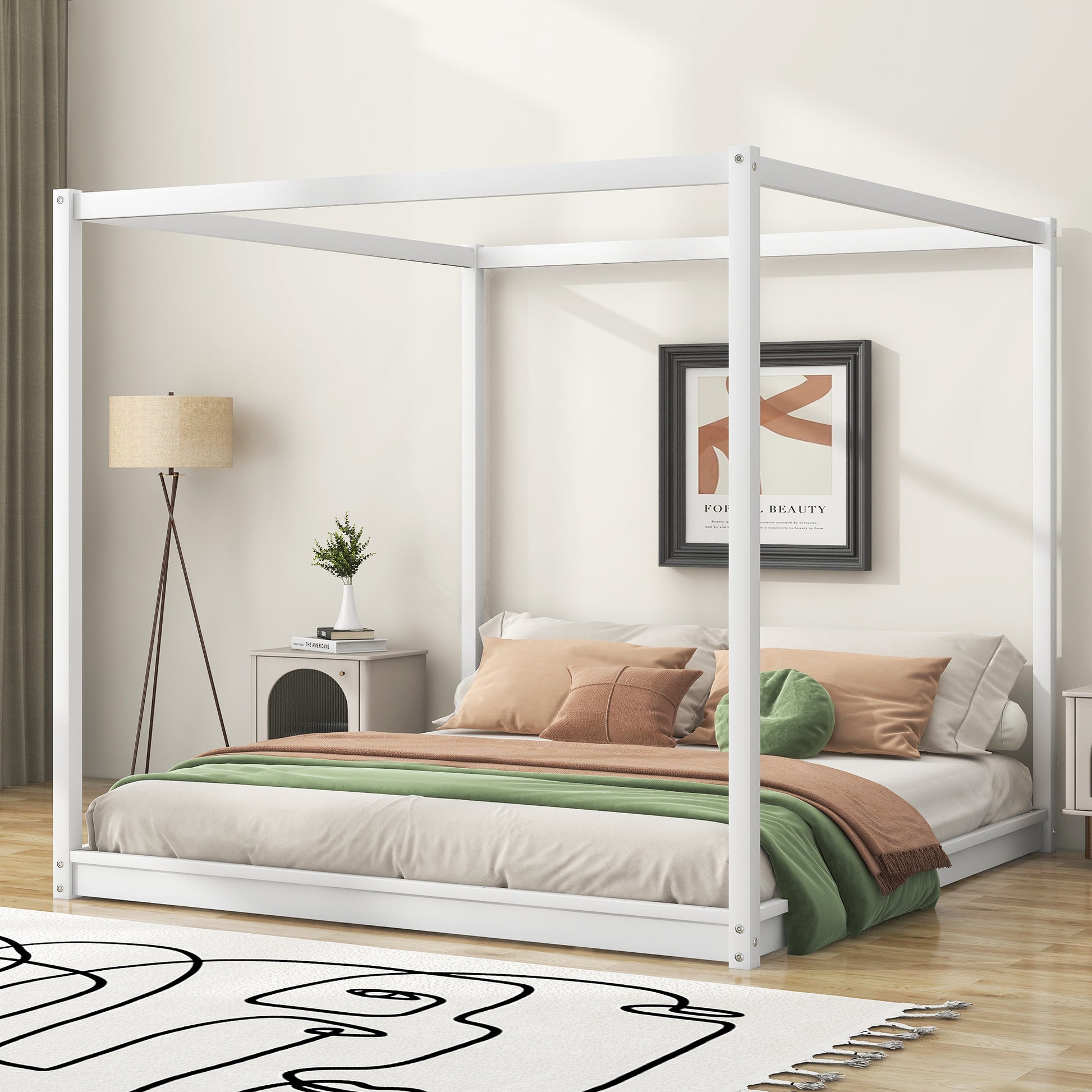 Modern white canopy bed with beige linens and green throw