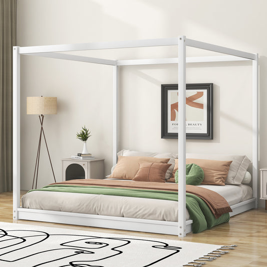 Modern white canopy bed with beige linens and green throw