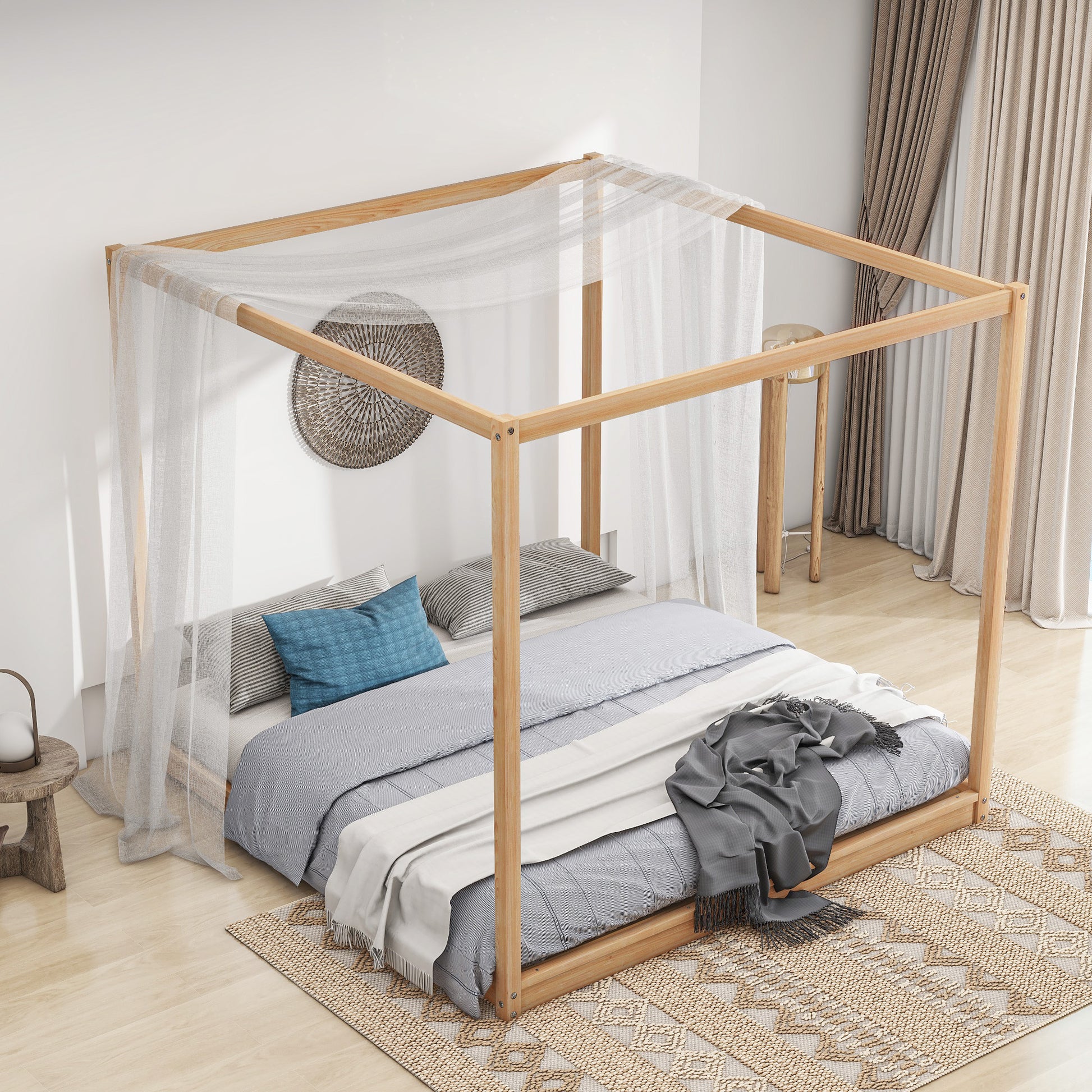 Natural wood fourposter bed frame with sheer white canopy and blue pillows