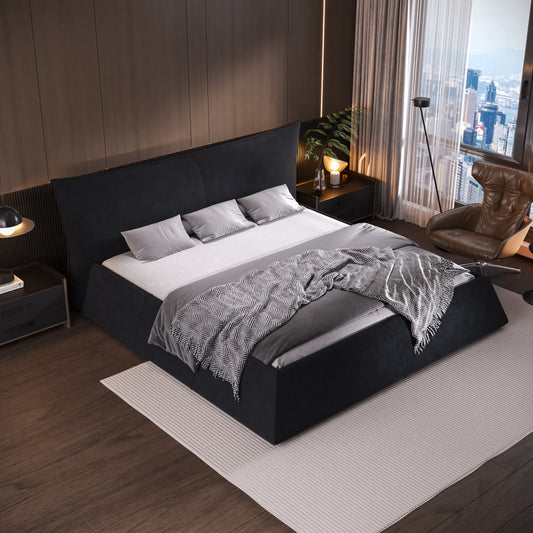 Dark grey fabric upholstered platform bed with three plush pillows