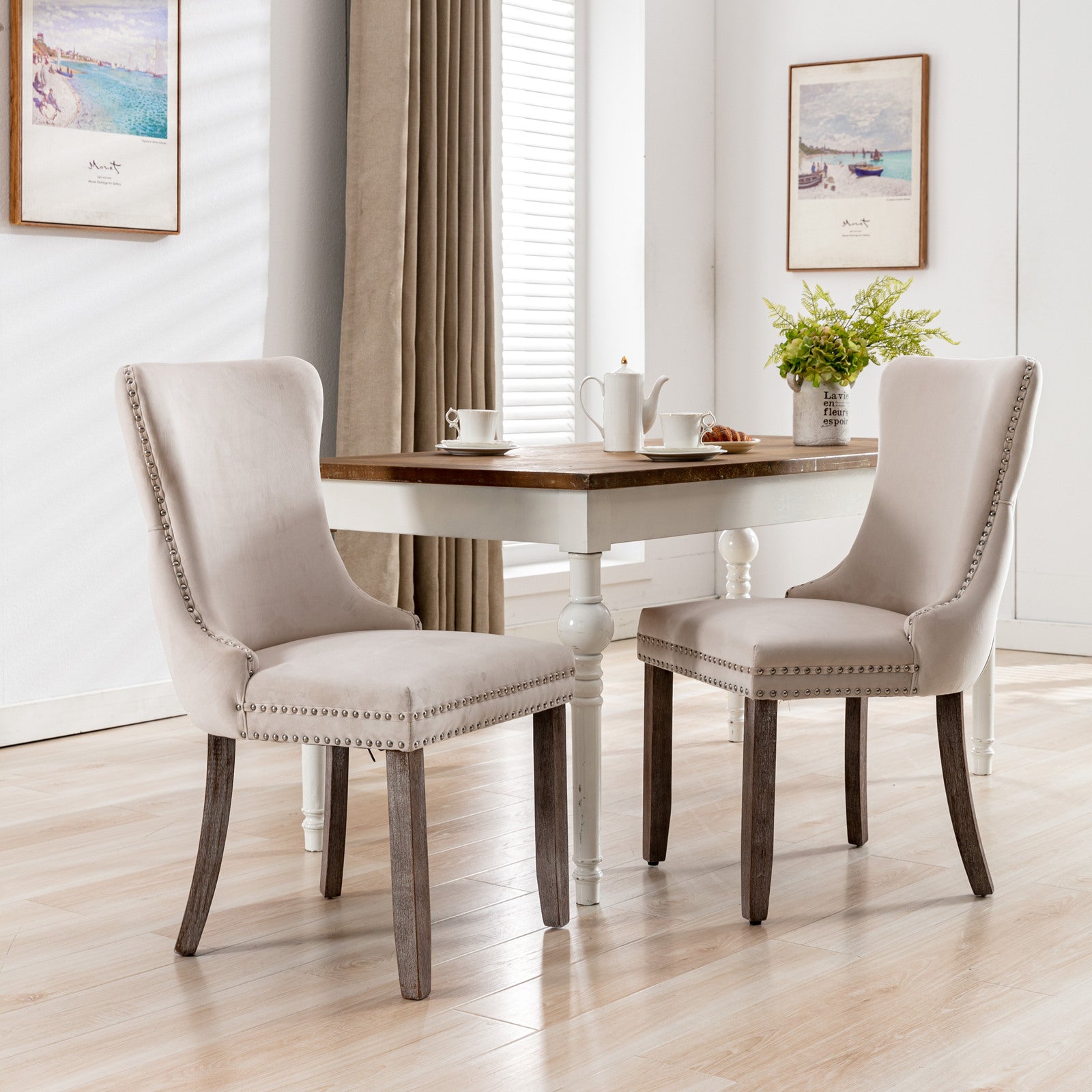 Upholstered dining chair in neutral beige velvet with silver nailhead trim