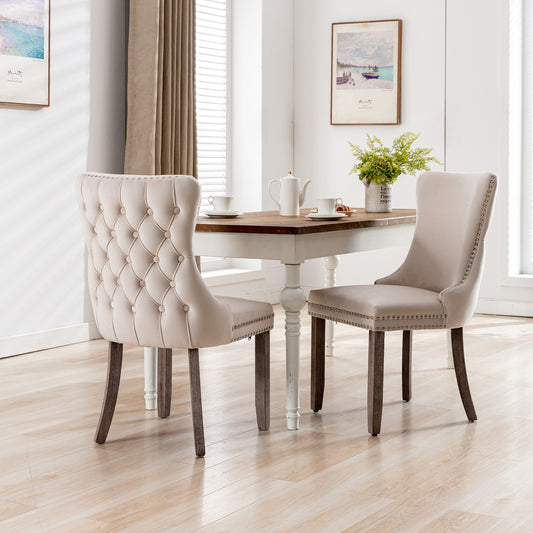 Tufted cream upholstered dining chair with silver nailhead trim