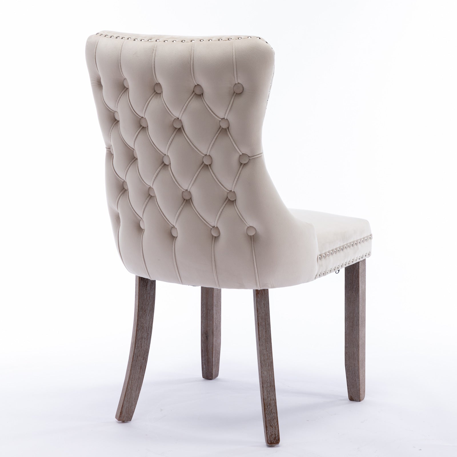Cream velvet tufted dining chair with antique brass nailhead trim and oak legs