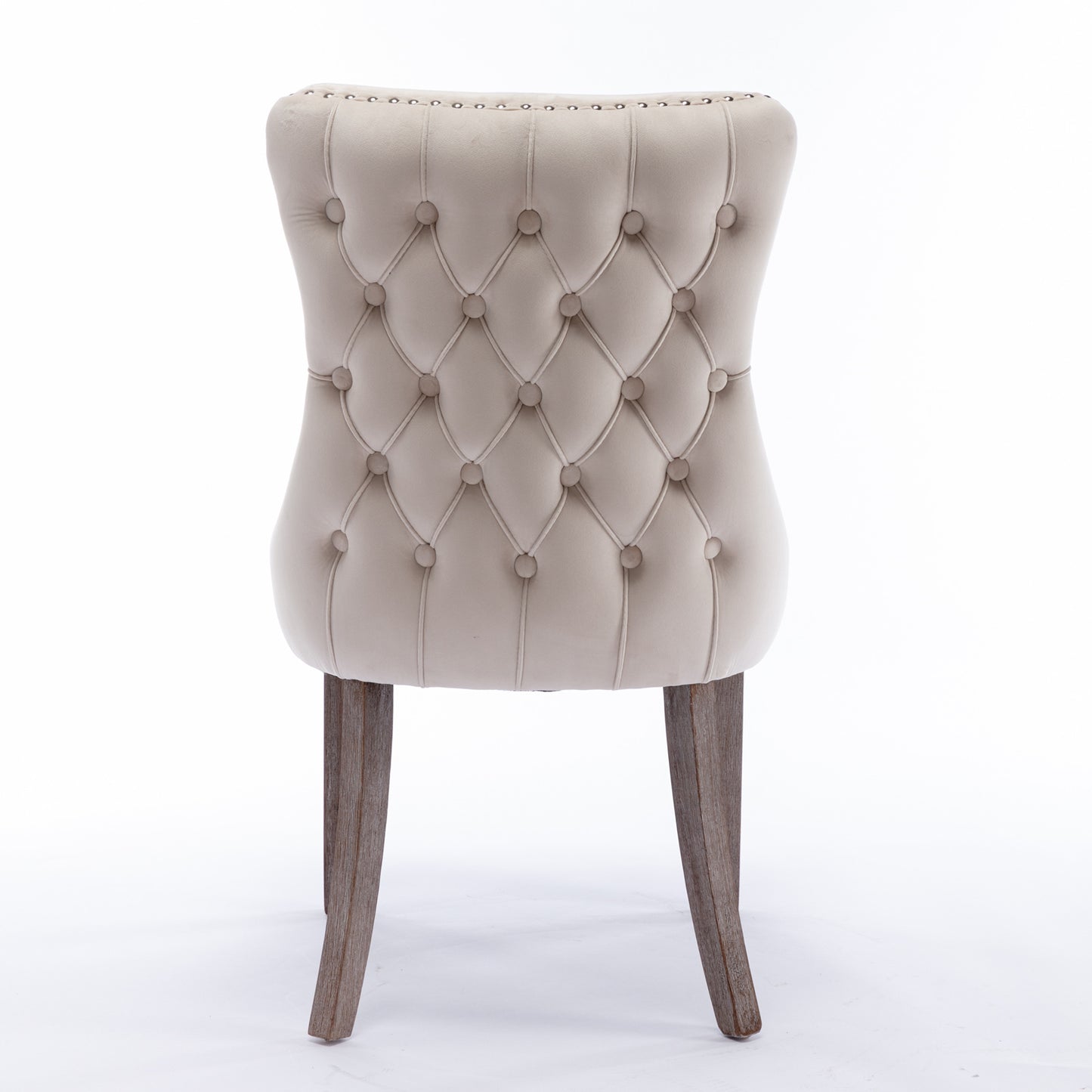 Beige velvet dining chair with tufted back and nailhead trim