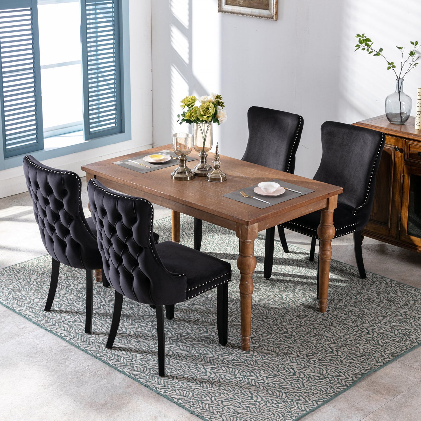 Black velvet tufted dining chair with silver nailhead trim