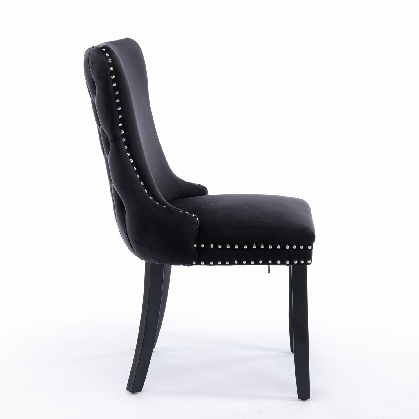 Black velvet tufted dining chair with silver nailhead trim