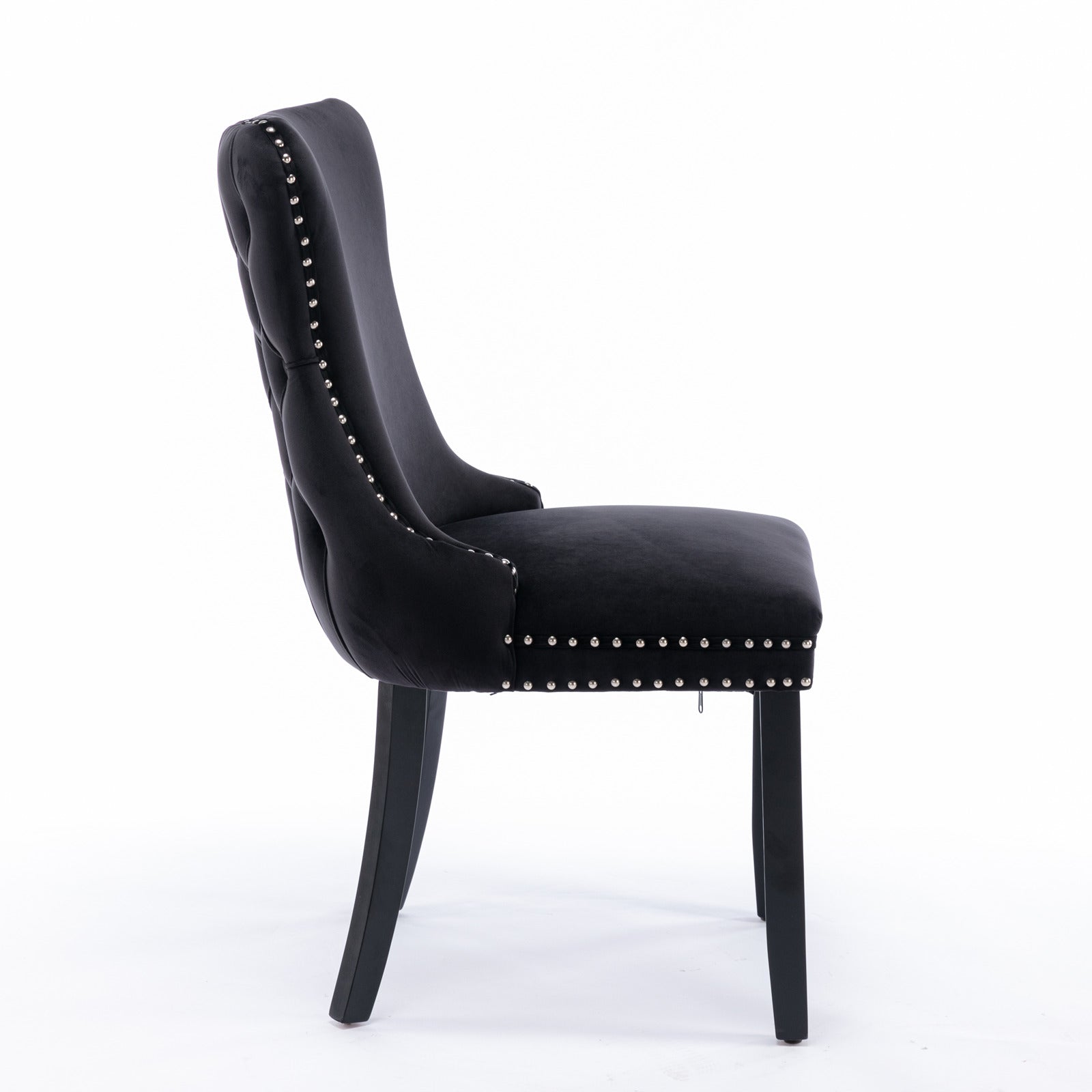Black velvet tufted dining chair with silver nailhead trim