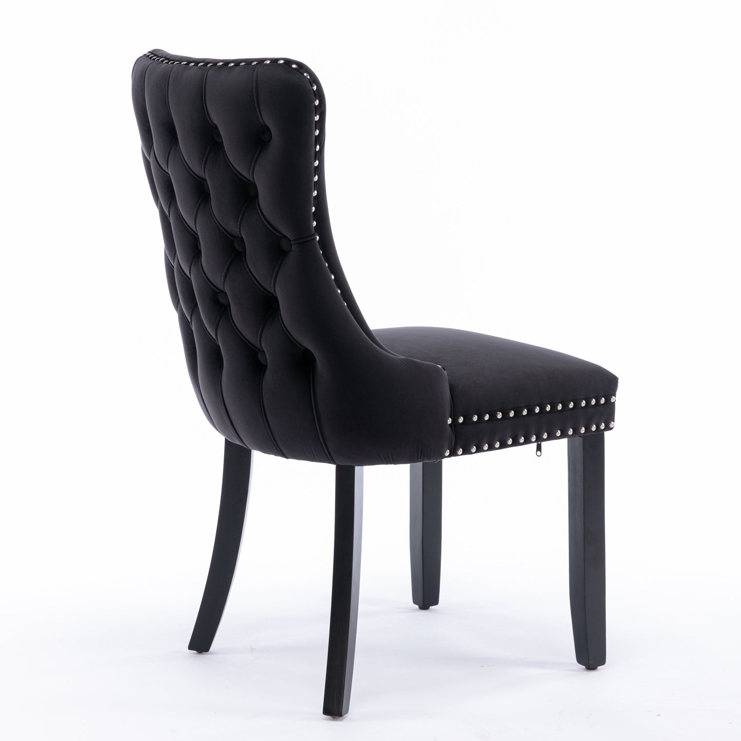 Black velvet tufted dining chair with silver nailhead trim and dark wooden legs