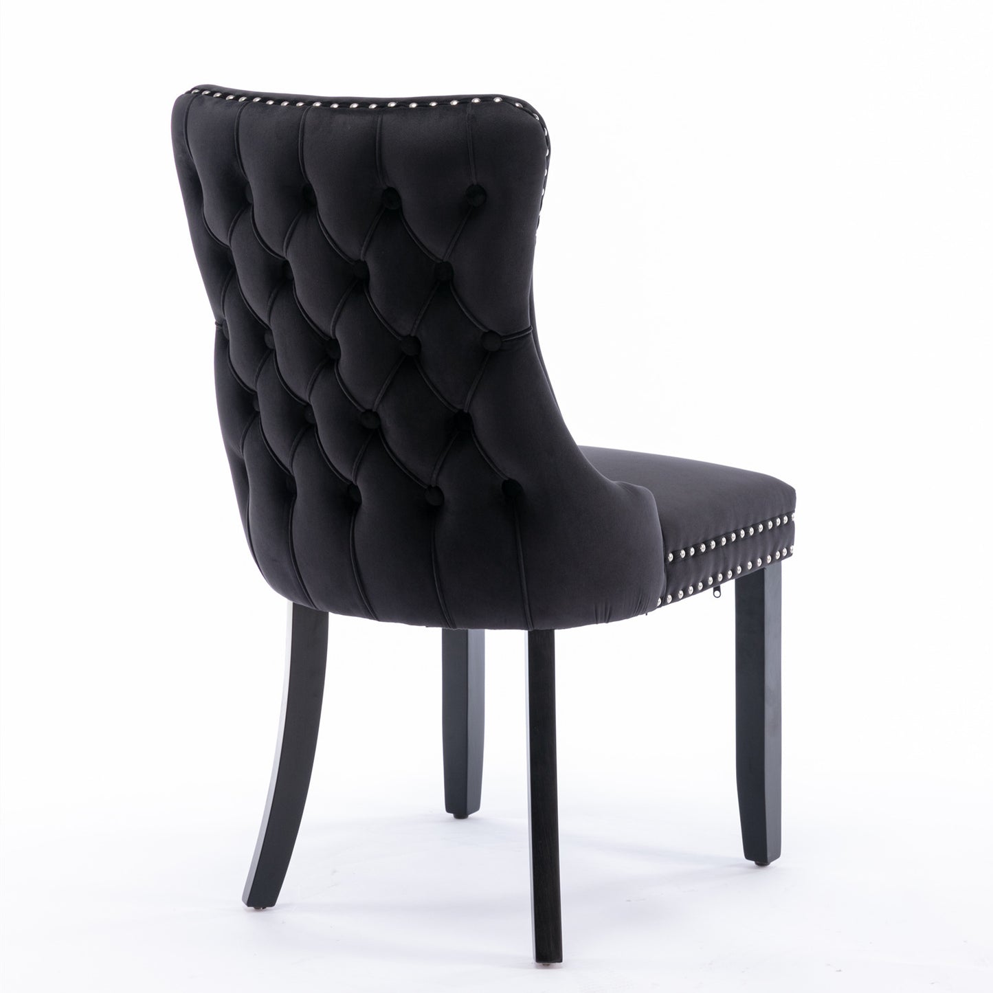 Black velvet dining chair with tufted back and silver nailhead trim