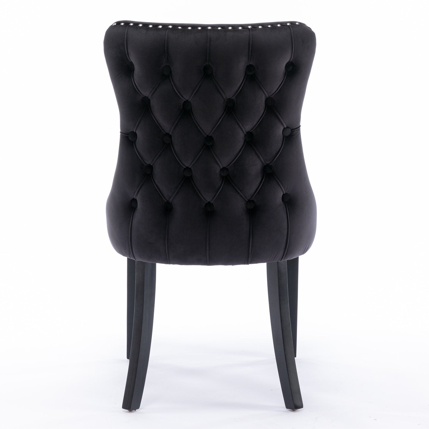 Black velvet dining chair with tufted back and nailhead trim
