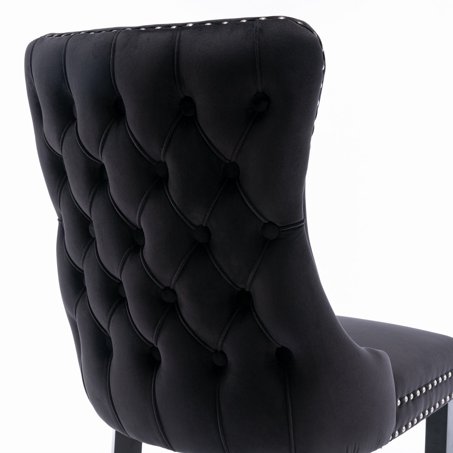 Black velvet tufted dining chair with silver nailhead trim details