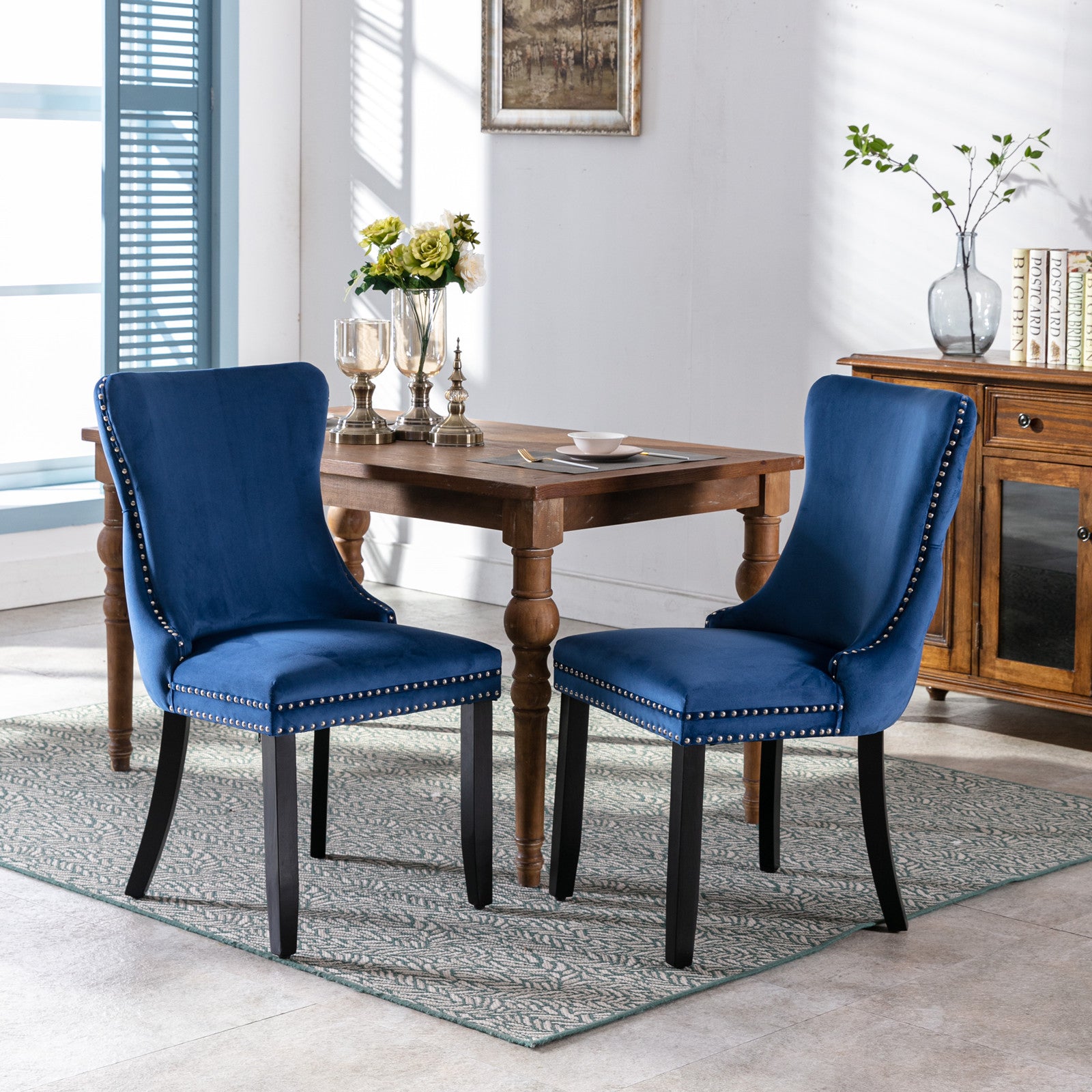 Deep blue velvet dining chair with silver nailhead trim