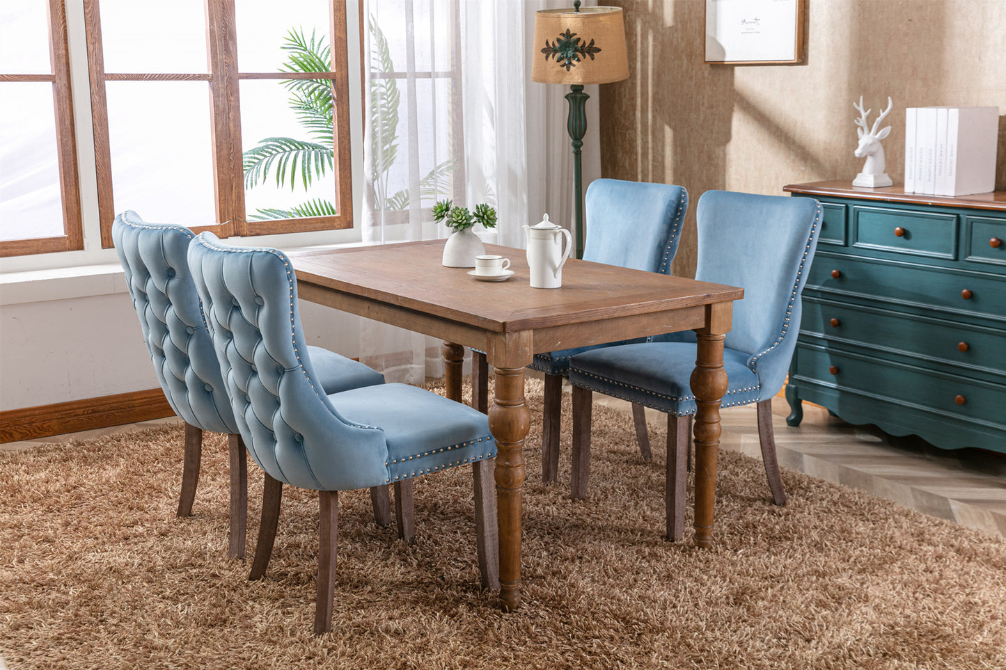 Light blue velvet dining chair with tufted back and nailhead trim