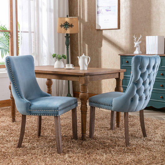 Sky blue velvet dining chair with tufted back and nailhead trim