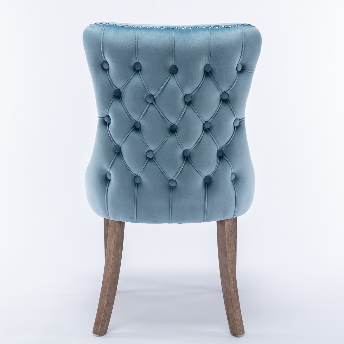 Blue velvet dining chair with button tufting and silver nailhead trim