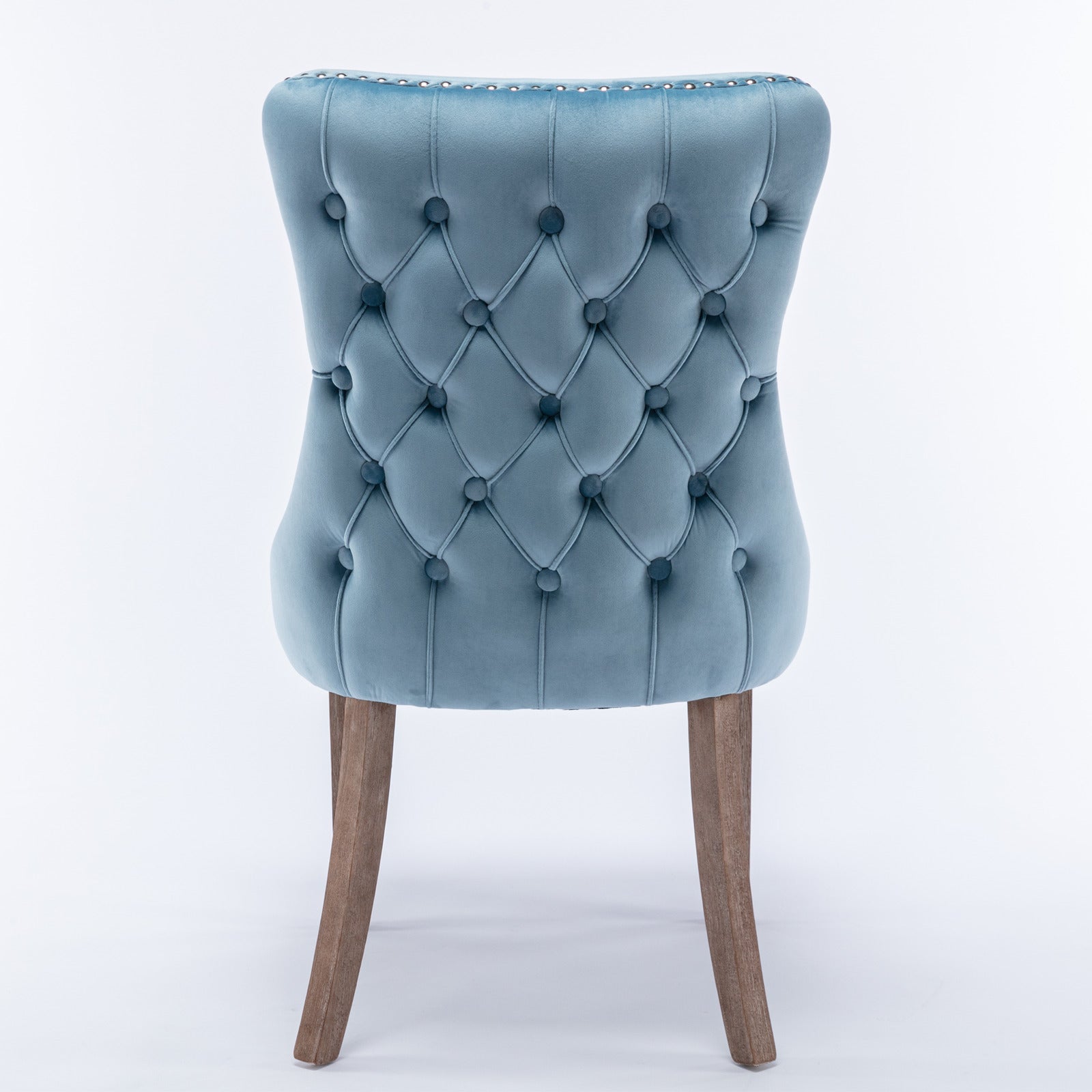 Blue velvet dining chair with button tufting and silver nailhead trim