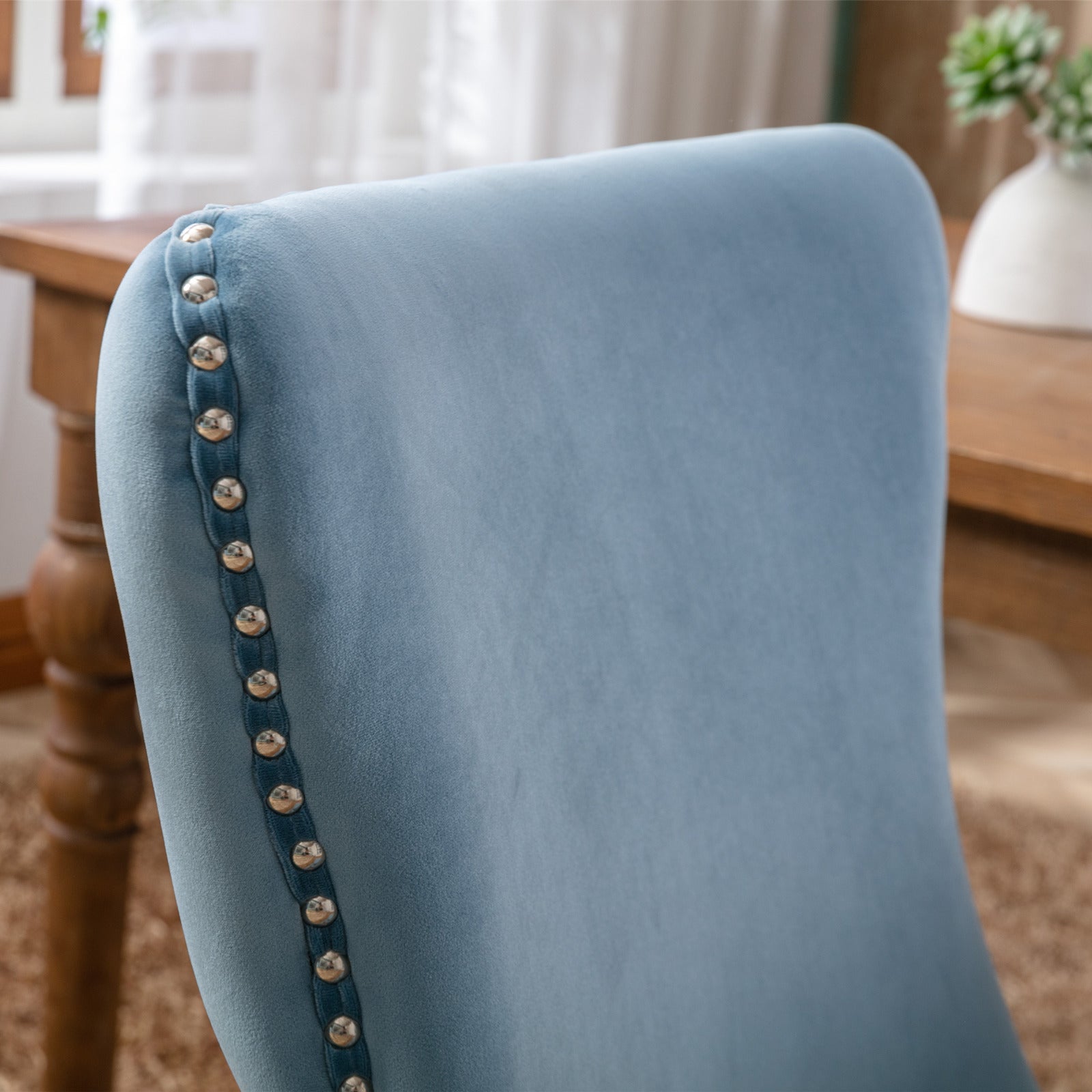 Light blue velvet accent chair with silver nailhead trim detail