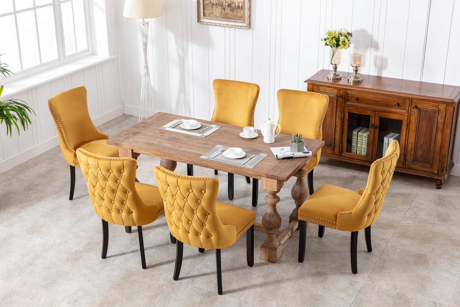 Tufted mustard velvet dining chair with nailhead trim and black legs