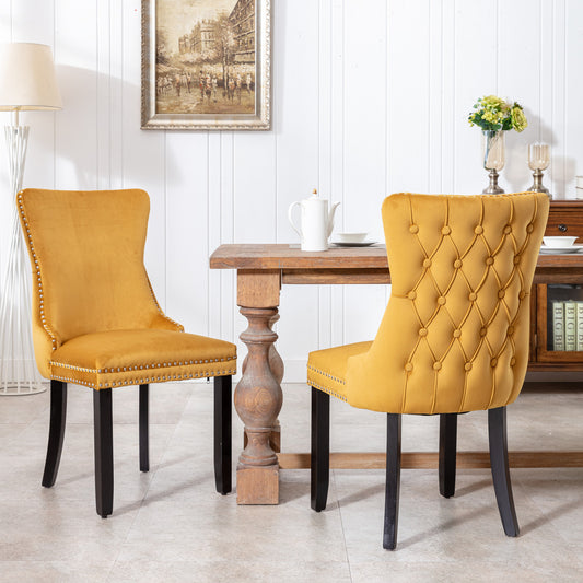 Mustard velvet dining chair with tufted back and silver nailhead trim
