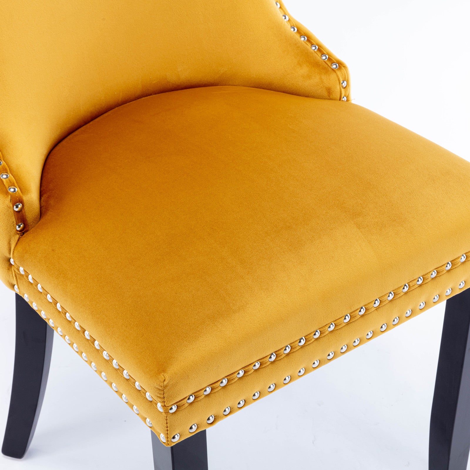 Yellow velvet accent chair with silver nailhead trim detail