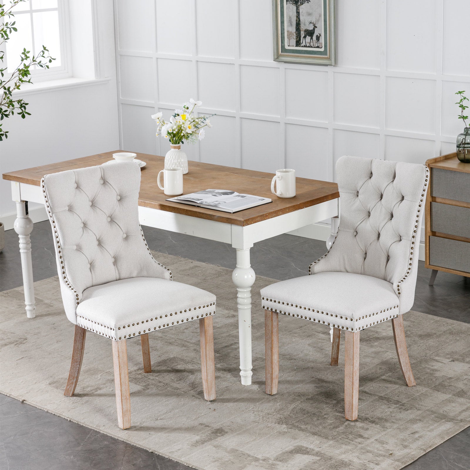 Elegant tufted dining chair in neutral beige linen with silver nailhead trim