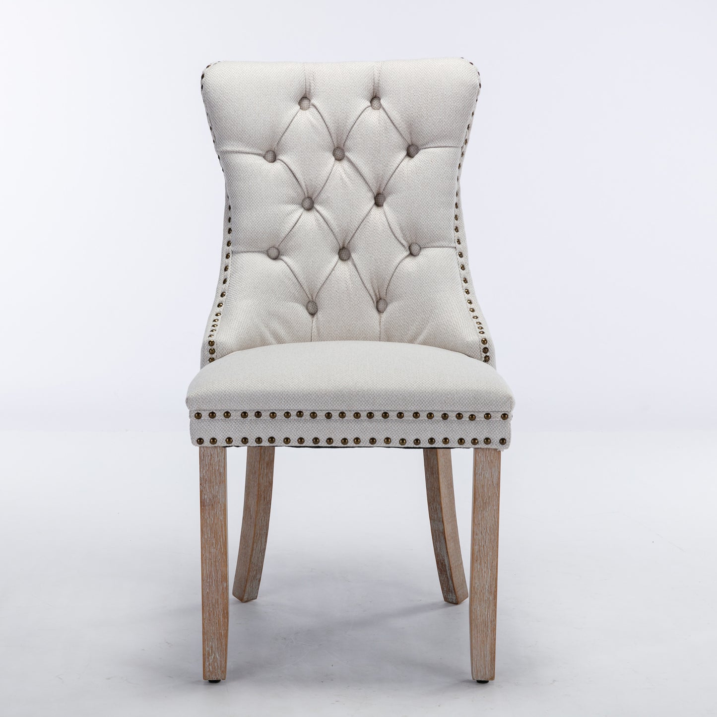 Tufted cream upholstered dining chair with nailhead trim and wooden legs